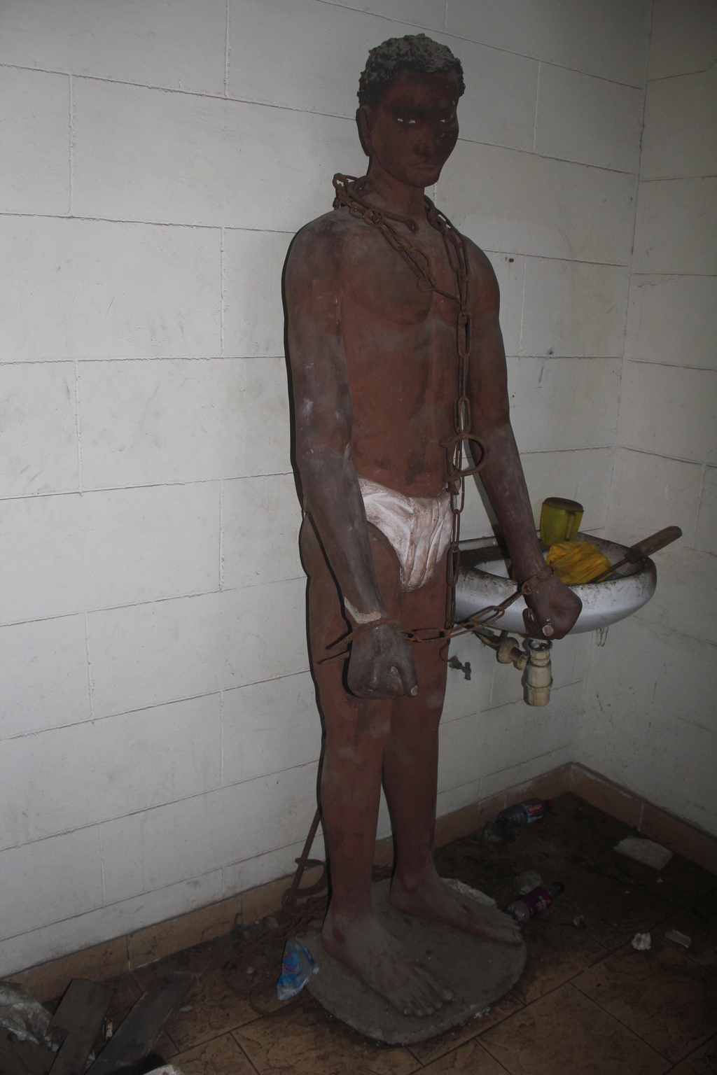 Former display of a slave, Fort Ussher Museum, Accra. Now abandoned in a storage bathroom, Ghana 2026