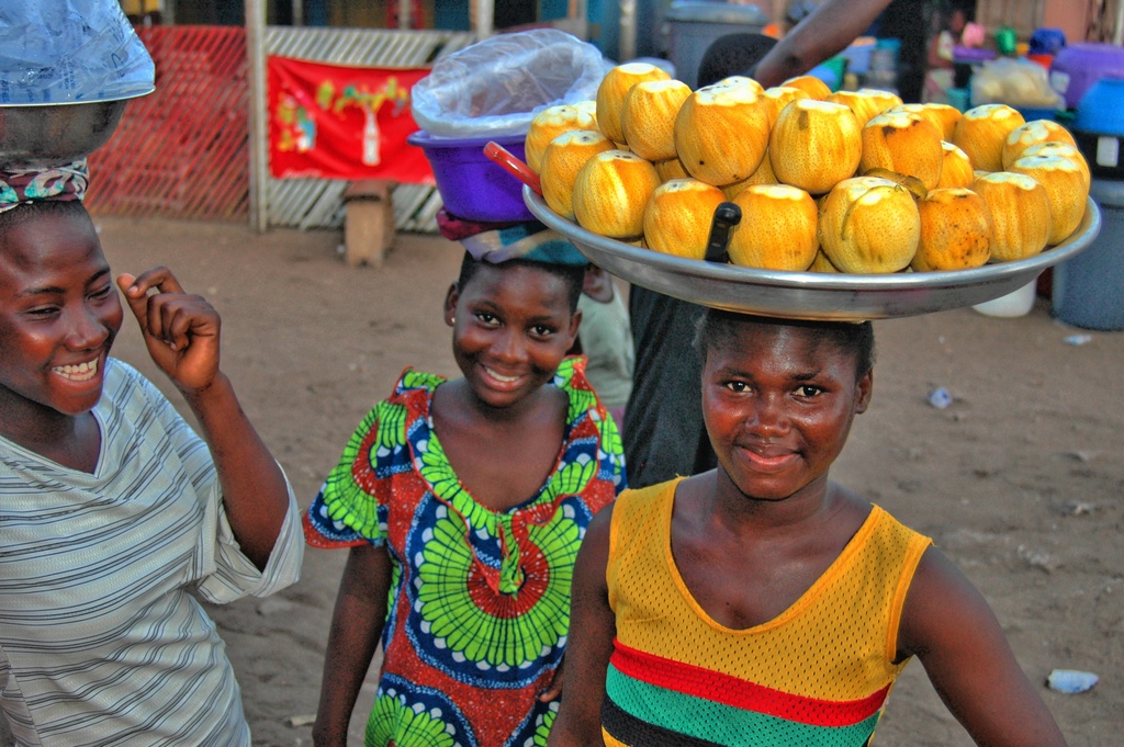Young girls offering water and oranges, Ghana, 2008 near Nungua police barrier
